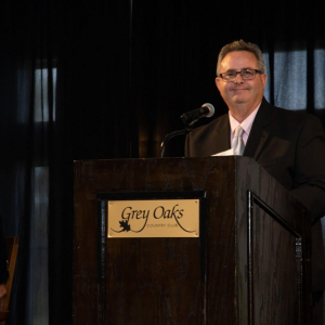 Scott standing at the podium during the Harvey Kapnick Award Ceremony
