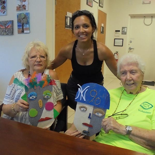 Three women posing with handmade face masks