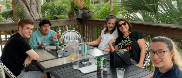 Friends dining at outdoor restaurant table