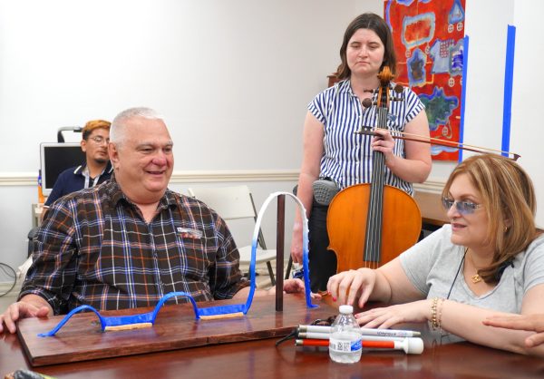 Group enjoying music therapy with cello