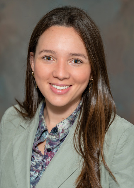 Professional headshot of smiling young woman